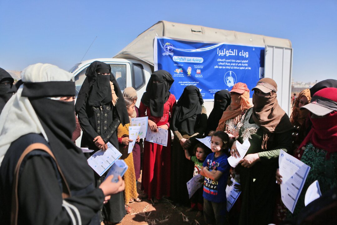 Syrians take part in a Cholera prevention and awareness campaign, held by a non-profit organization, at a camp for internally displaced people in the town of Sarmada in Syria's northwestern Idlib province on Sept. 25, 2022. (Aaref Watad/AFP via Getty Images)