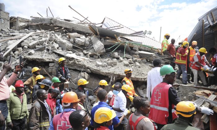 Rescuers search through a multi-story collapsed apartment building in Kirigiti, Kiambu County, Kenya, on Sept. 26, 2022. (John Muchucha/AP Photo)