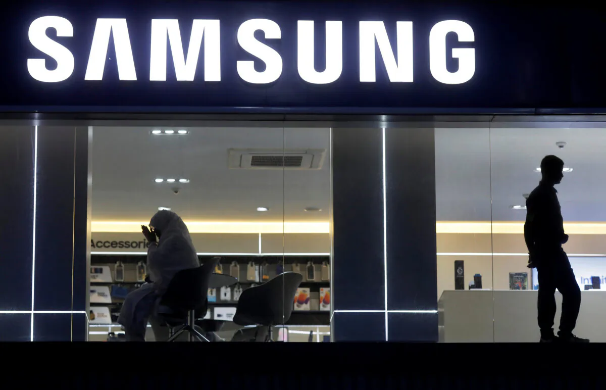 A customer prays inside a Samsung showroom in New Delhi on July 27, 2018. (Adnan Abidi/Reuters)