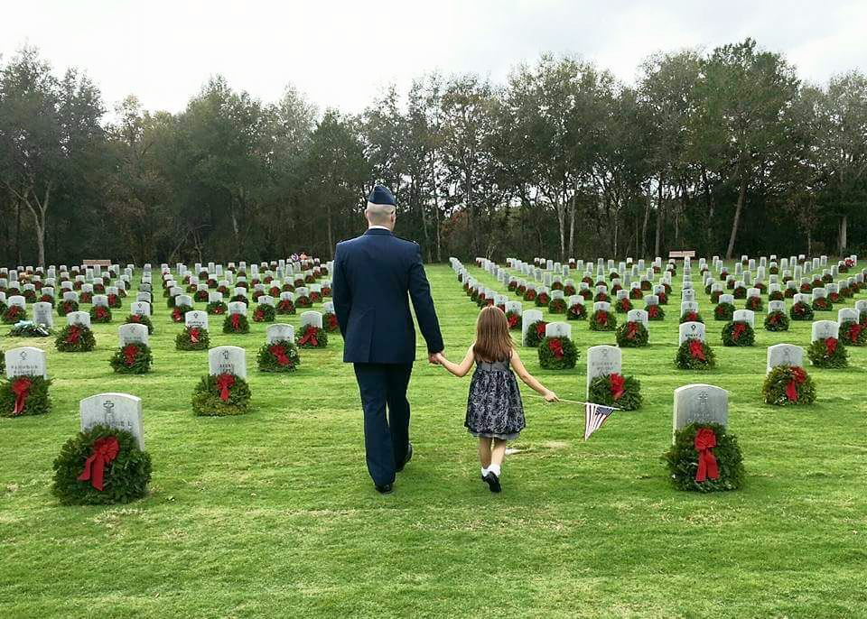Both young and old appreciate the wreaths provided to national, state, and community cemeteries across the country.  (Courtesy of Wreaths Across America)