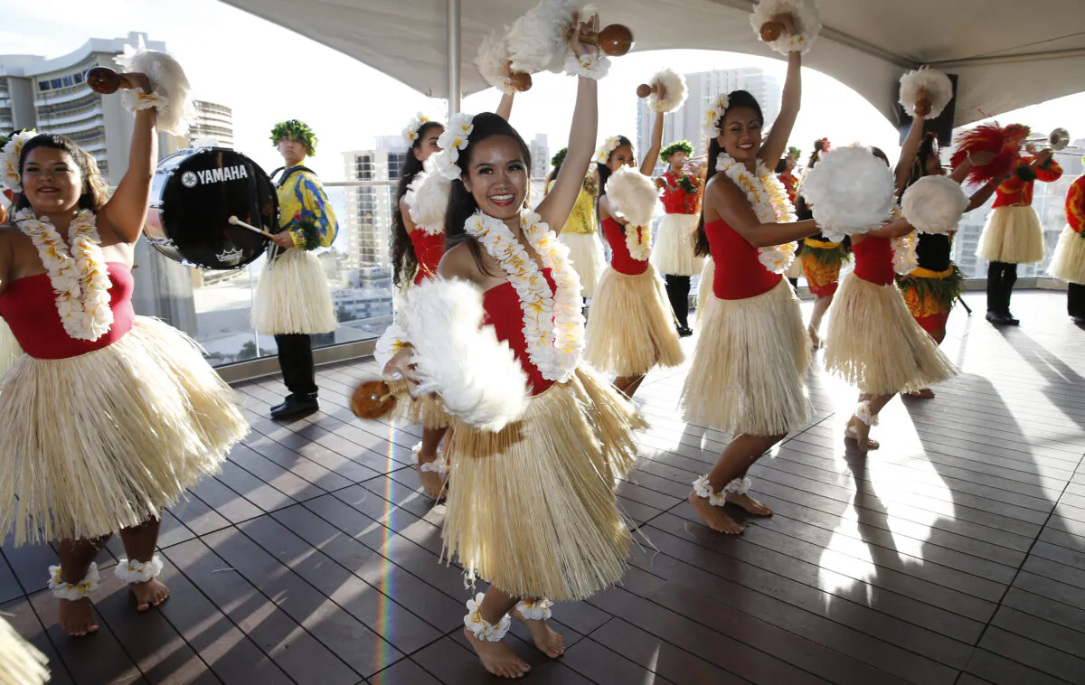 Hula dancers and members of the Hawaii All State Marching Band perform in June 13, 2016. (Marco Garcia/Getty Images for Macy's)