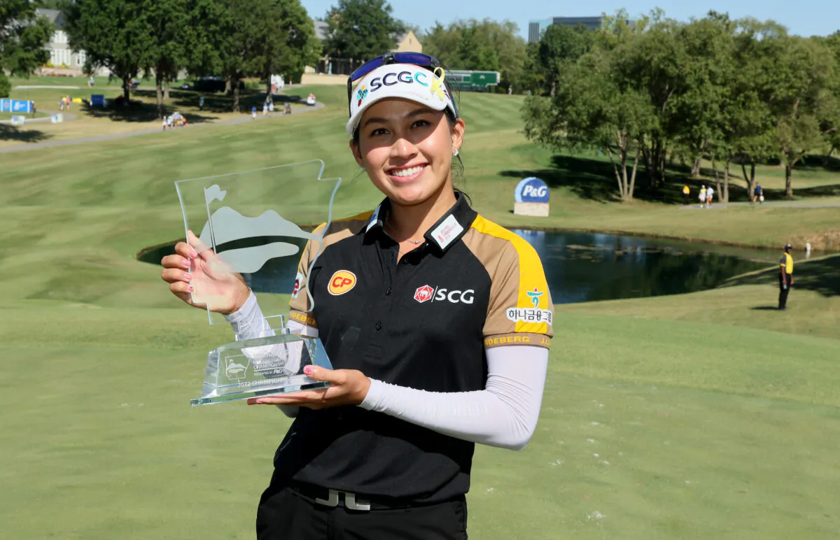 Atthaya Thitikul of Thailand holds the winner's trophy after winning the Walmart NW Arkansas Championship at Pinnacle Country Club in Rogers, Ark., on Sept. 25, 2022. (Andy Lyons/Getty Images)