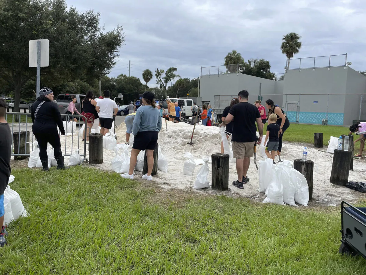 People make sandbags at MacFarlane Park, one of the city of Tampa's three sandbag sites, in Tampa, Fla., on Sept. 25, 2022. (Luis Santana/Tampa Bay Times via AP)