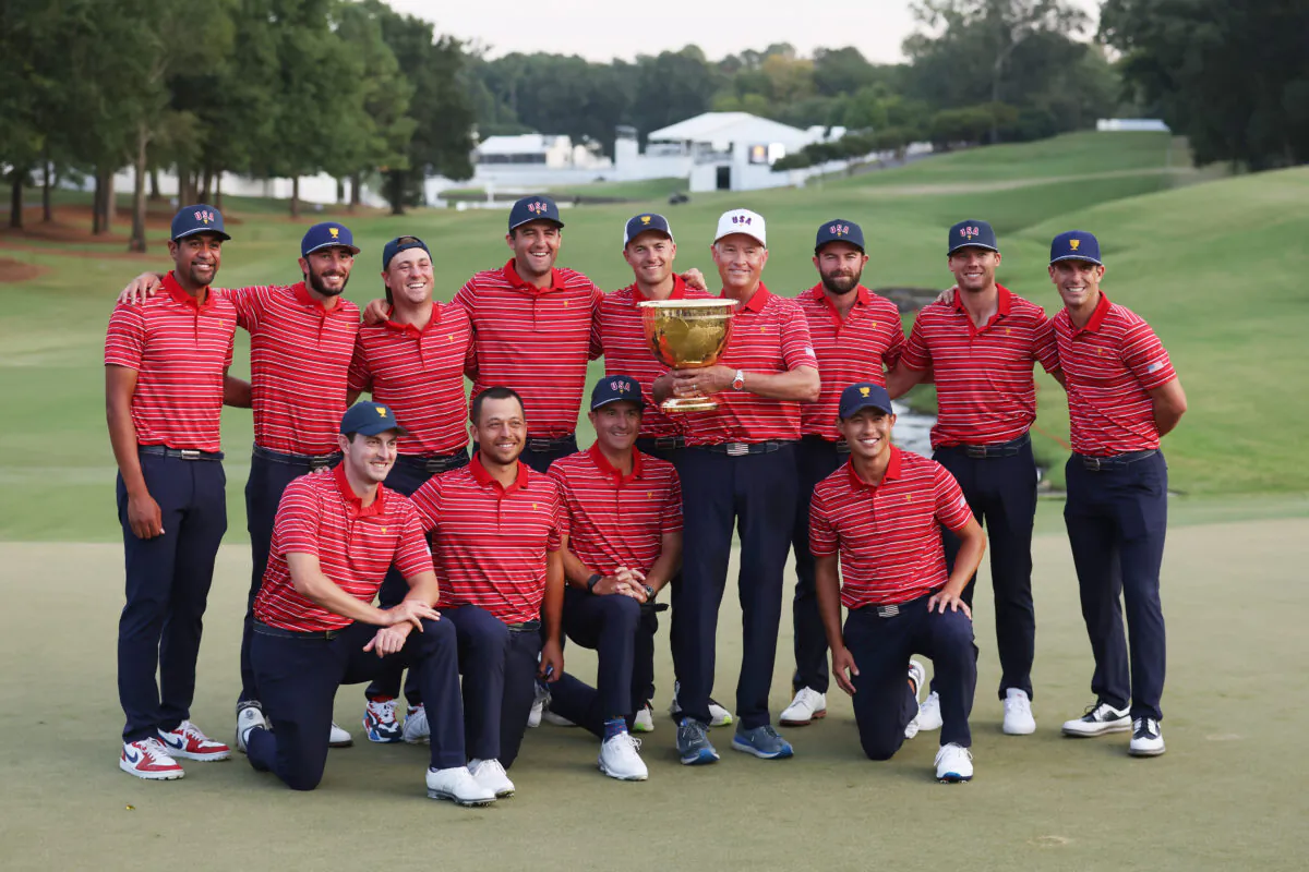 (Back L-R) Tony Finau, Max Homa, Justin Thomas, Scottie Scheffler, Jordan Spieth, Captain Davis Love III, Cameron Young, Sam Burns, Billy Horschel (Front L-R) Patrick Cantlay, Xander Schauffele, Kevin Kisner and Collin Morikawa of the United States Team pose with the Presidents Cup after defeating the International Team during Sunday singles matches on day four of the 2022 Presidents Cup at Quail Hollow Country Club in Charlotte, N.C., on Sept. 25, 2022. (Warren Little/Getty Images)