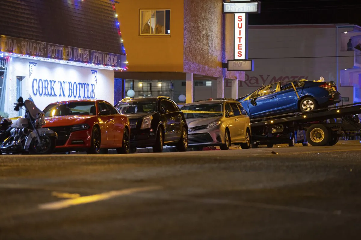 A blue Honda is loaded onto a flatbed tow truck in Wildwood, N.J., on Sept. 24, 2022. (Dave Hernandez/NJ Advance Media via AP)