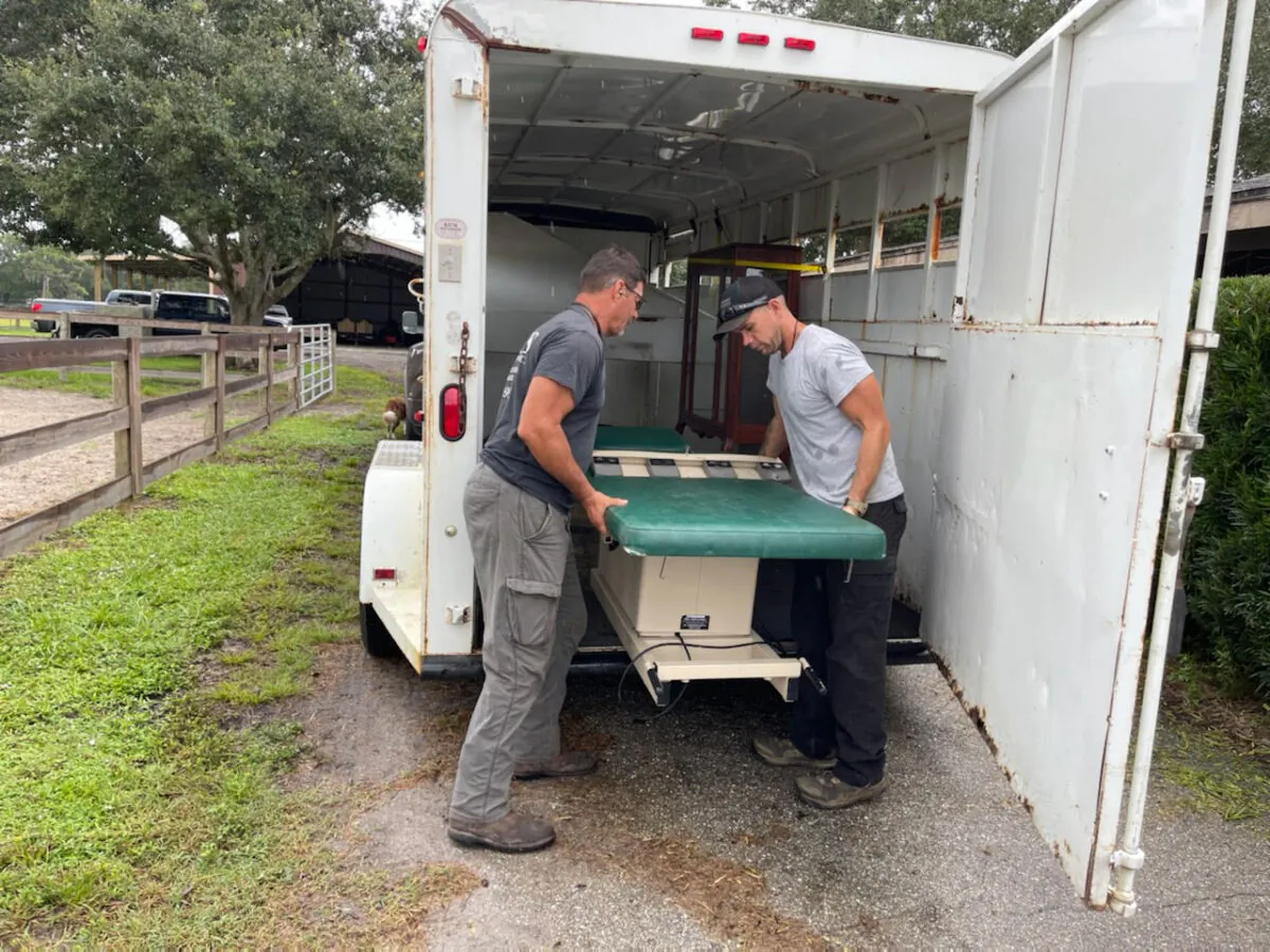 Carl Mottler (L) and employee Jordan Carlson unload medical equipment at Mottler's ranch in Punta Gorda, Fla., on Sept. 27, 2022. (Courtesy of Lisa Mottler)