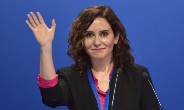 Madrid regional president Isabel Díaz Ayuso waves before delivering a speech during the 20th National Congress of the Popular Party (PP) at the Fibes conference and exhibition centre in Seville on April 1, 2022. (Cristina Quicler/AFP via Getty Images)