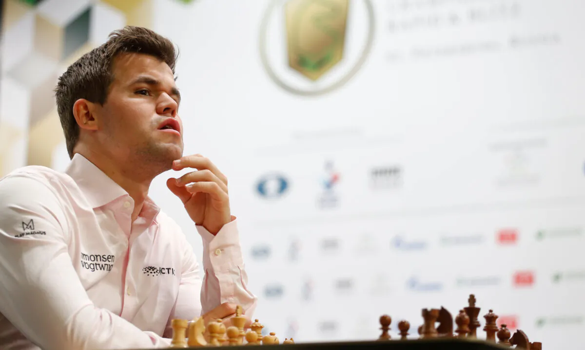 Magnus Carlsen of Norway sits in front of a chess board before a game at the 2018 World Rapid and Blitz Chess Championships in Saint Petersburg, Russia, on Dec. 26, 2018. (Anton Vaganov/Reuters)