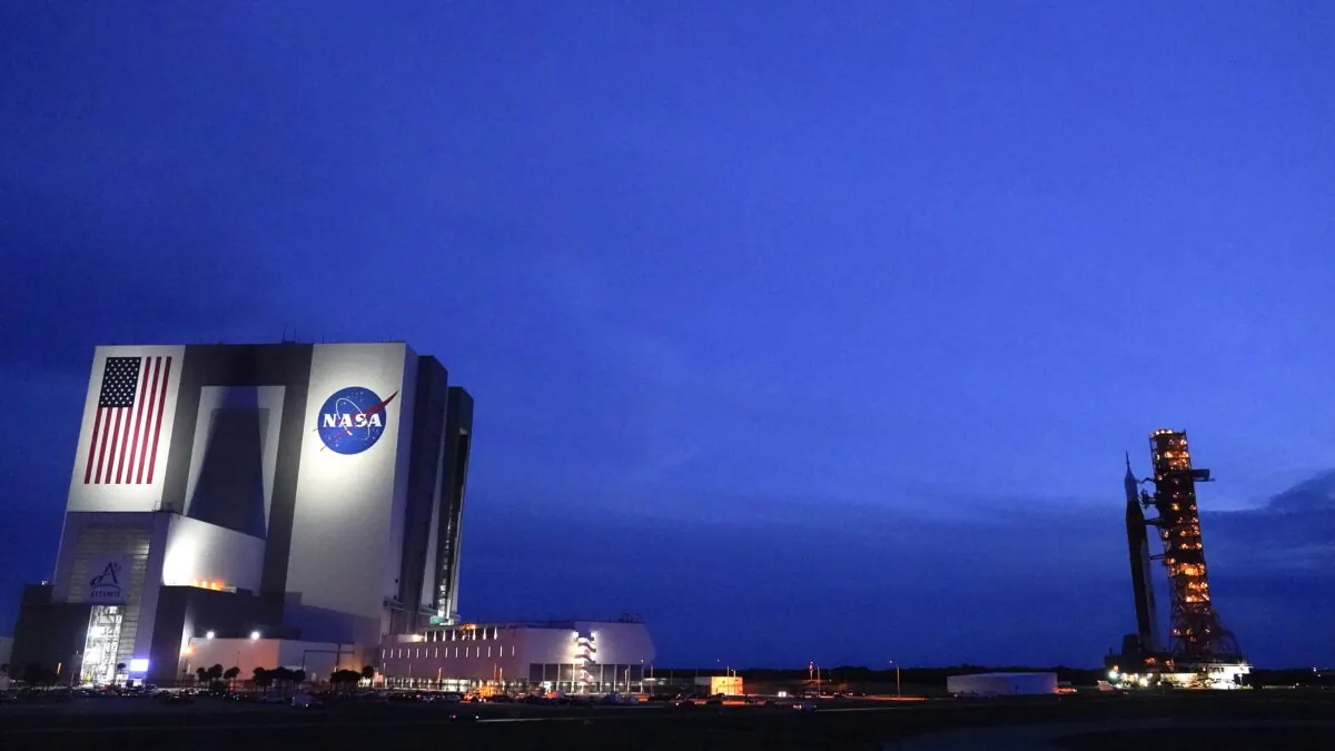 The NASA moon rocket (R) slated for the Artemis mission to the moon rolls back to the Vehicle Assembly Building at the Kennedy Space Center in Cape Canaveral, Fla., on Sept. 27, 2022. (John Raoux/AP Photo)