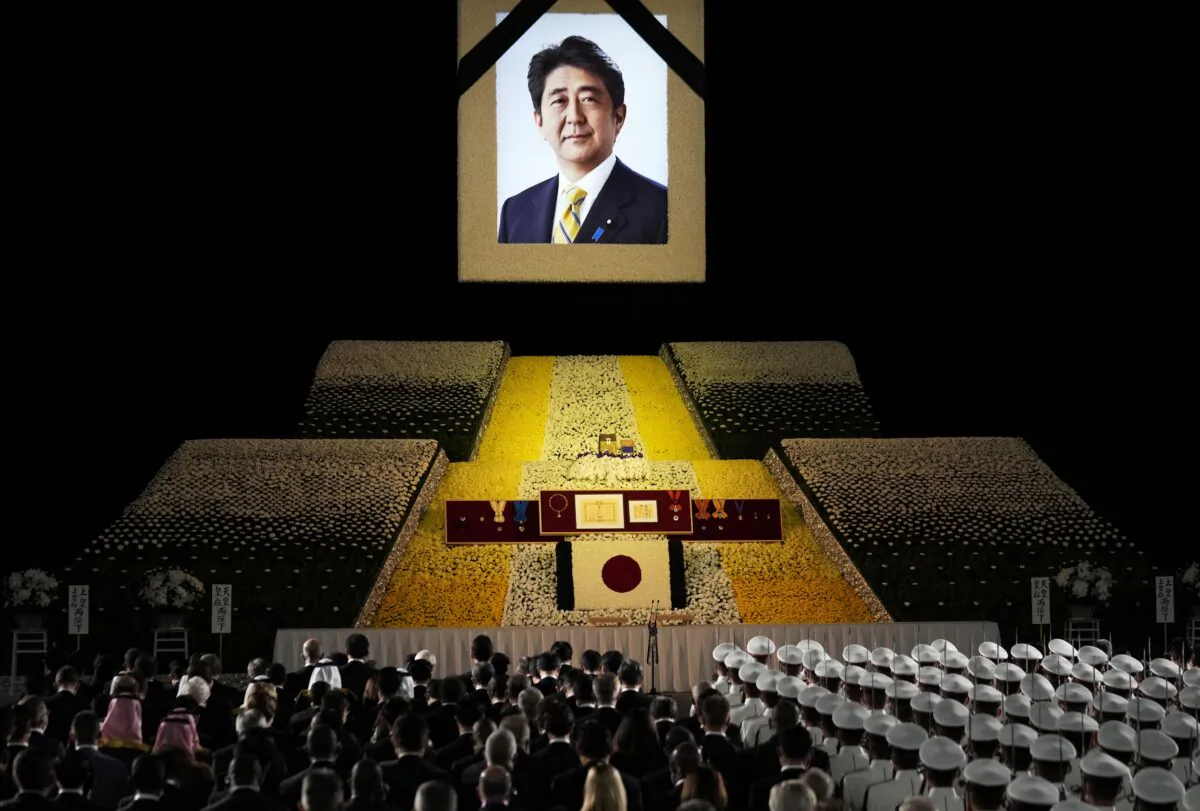 A portrait of former Japanese Prime Minister Shinzo Abe hangs on the stage during his state funeral in Tokyo on Sept. 27, 2022. (Franck Robichon/Pool Photo via AP)