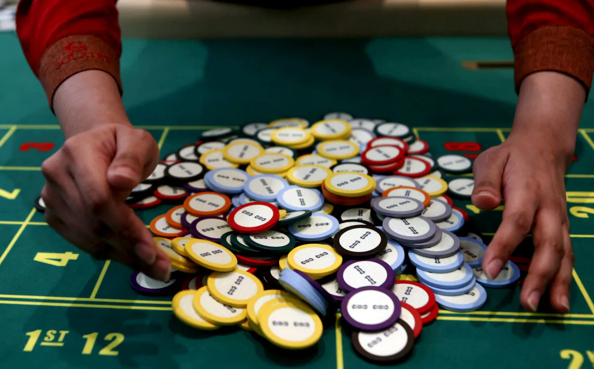 File photo of a casino dealer collects chips at a roulette table. (Erik De Castro/Reuters)