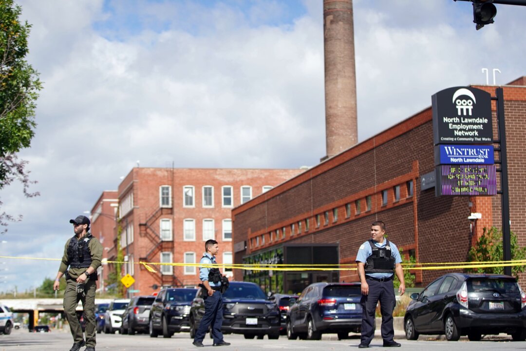 Officers set up crime tape outside a Chicago Police Department building in Homan Square in Chicago on Sept. 26, 2022. (Anthony Vazquez/Chicago Sun-Times via AP)