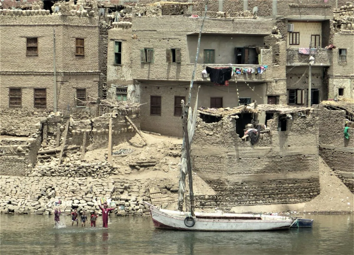 Locals play in the water and wave to visitors along the Nile River in Egypt. (Victor Block)