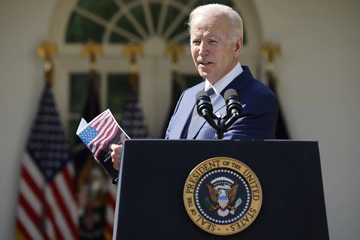 President Joe Biden holds up a piece of paper he says highlights a plan by Sen. Rick Scott (R-Fla.) while delivering remarks about lowering health care costs in the Rose Garden at the White House on Sept. 27, 2022. (Chip Somodevilla/Getty Images)