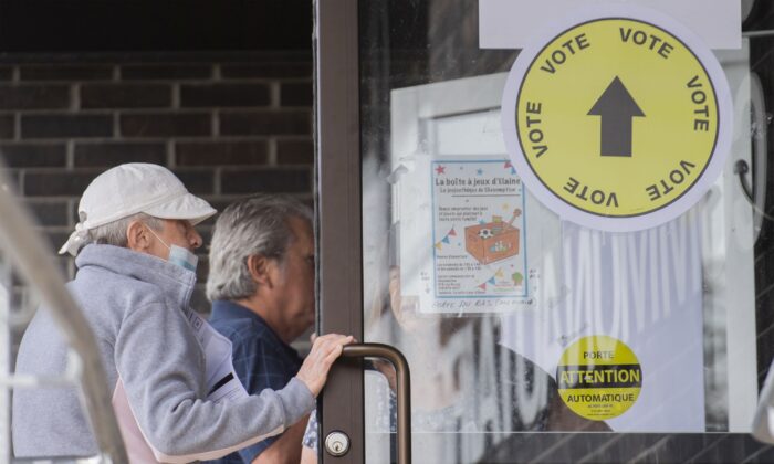 People enter a polling station in L'Assomption, Que., on Sept. 25, 2022, as advanced polling begins ahead of the provincial election on Oct. 3. (The Canadian Press/Graham Hughes)
