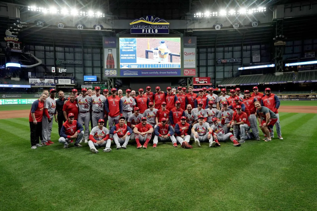 Members of the St. Louis Cardinals gather on the field for a photo after defeating the Milwaukee Brewers in a baseball game to win the National League Central title in Milwaukee, Wis., on Sept. 27, 2022. (Morry Gash/AP Photo)