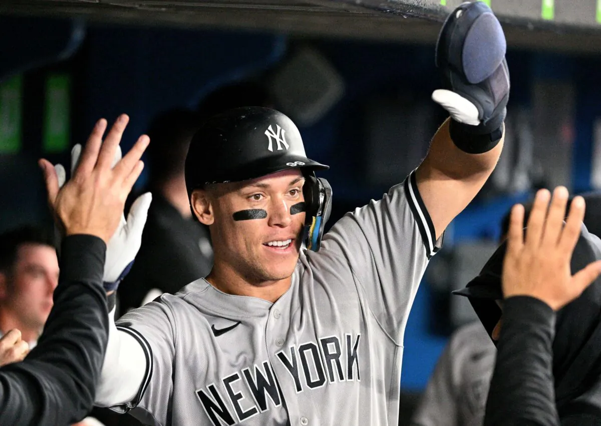 New York Yankees center fielder Aaron Judge (99) celebrates in the dugout with team mates after scoring against the Toronto Blue Jays in the third inning at Rogers Centre in Toronto on Sept. 27, 2022. (Dan Hamilton/USA TODAY Sports)