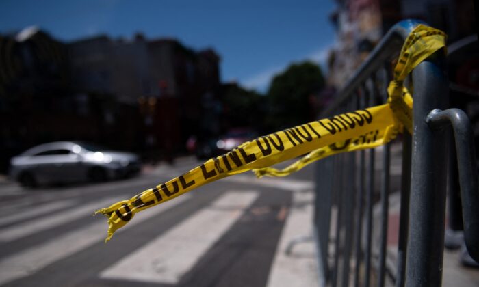 Police tape hangs from a barricade at the corner of South and 3rd Streets in Philadelphia, Pa., on June 5, 2022, the day after three people were killed and 11 others wounded by gunfire all within a few blocks. (Kriston Jae Bethel/AFP via Getty Images)