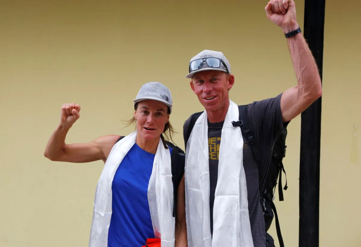 Hilaree Nelson of Telluride, Colorado, (L) and James Morrison of Tahoe, California, raise their fists as the pair arrived in Kathmandu, Nepal, on Oct. 4, 2018. (Niranjan Shrestha/AP Photo)