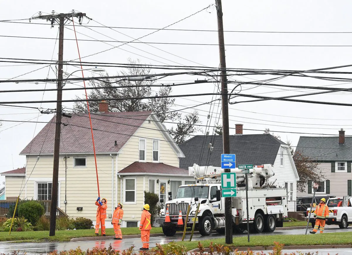 Crews from Nova Scotia Power work on reconnecting the power grid to the Glace Bay Hospital knocked out by Hurricane Fiona, in Glace Bay, N.S., Sept. 26, 2022. (The Canadian Press/Vaughan Merchant)