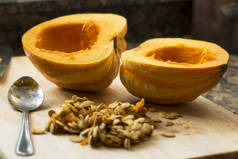 Winter,Squash,Cut,In,Half,With,Spoon,And,Seeds,Scooped