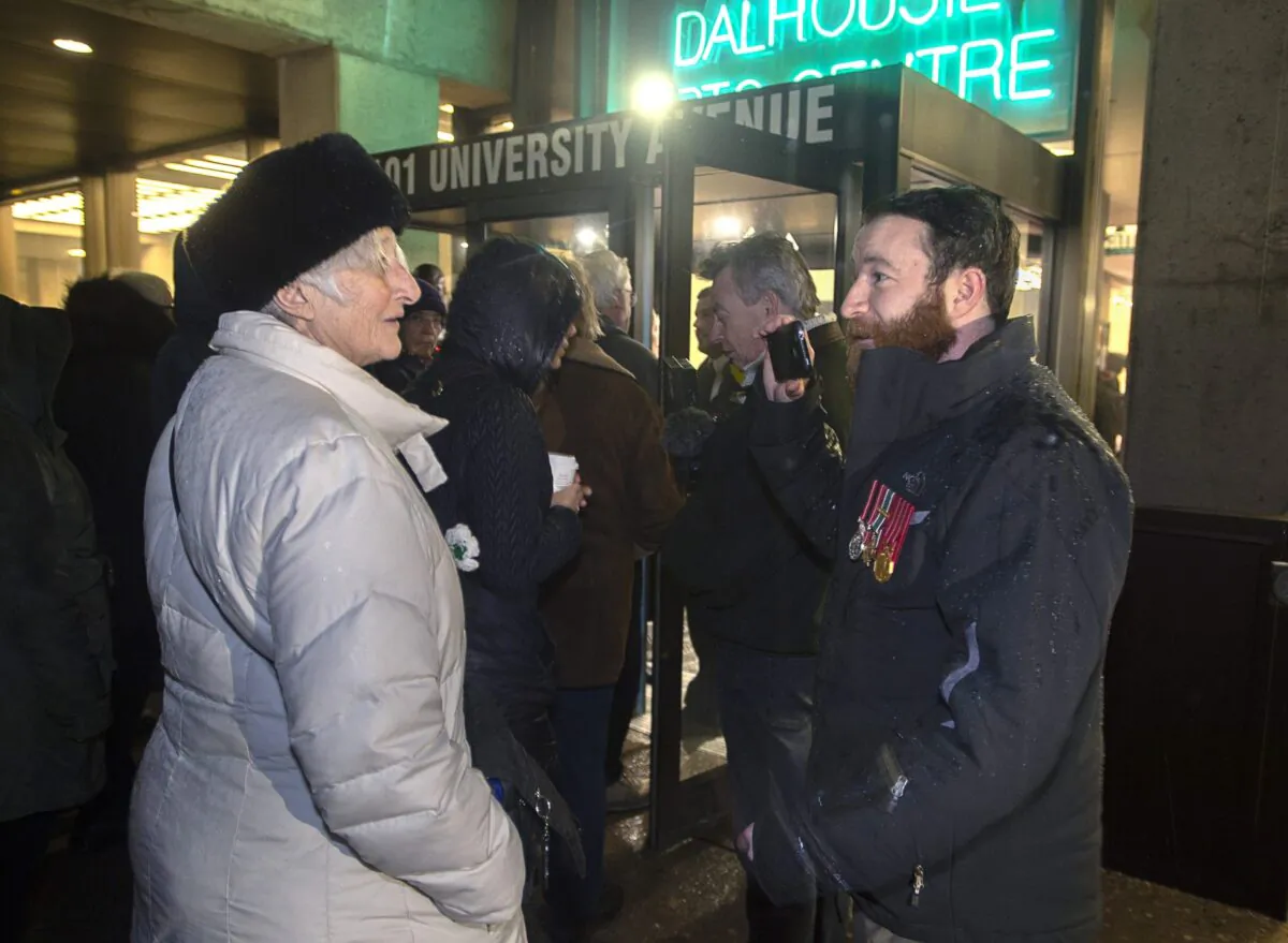 Jeremy MacKenzie (R) talks with an unidentified woman outside the venue where former child soldier Omar Khadr is speaking, in Halifax on Feb. 10, 2020. (The Canadian Press/Andrew Vaughan)

