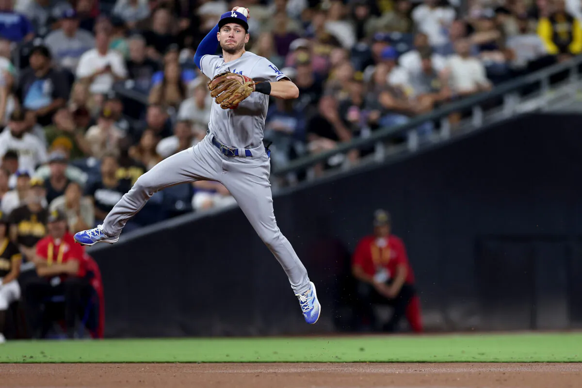 Trea Turner (6) of the Los Angeles Dodgers throws out Jake Cronenworth (9) of the San Diego Padres on an infield grounder during the second inning of a game at PETCO Park in San Diego, on Sept. 28, 2022. (Sean M. Haffey/Getty Images)