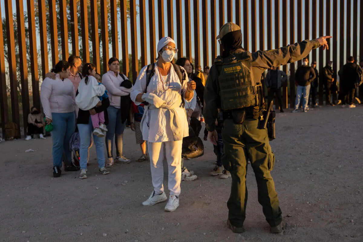 Illegal immigrants wait to be processed by U.S. Border Patrol agents after crossing 
 from Mexico into Arizona near Yuma, 
 on Sept. 26, 2022. (John Moore/Getty Images)