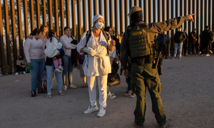 Immigrants seeking asylum in the United States wait to be processed by U.S. Border Patrol agents after crossing into Arizona from Mexico near Yuma, Ariz., on Sept. 26, 2022. (John Moore/Getty Images)