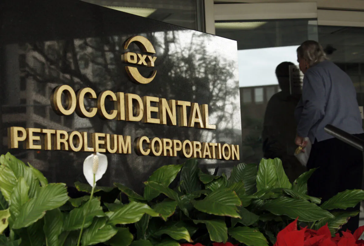 An employee enters the Occidental Petroleum headquarters building in Los Angeles on Jan. 29, 2010. (Reed Saxon/AP Photo)