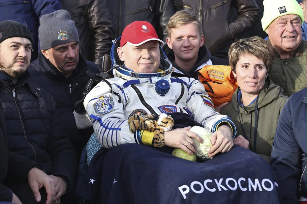 Russian cosmonaut Oleg Artemyev sits in the chair shortly after the landing of the Russian Soyuz MS-21 space capsule southeast of the Kazakh town of Zhezkazgan, Kazakhstan, on Sept. 29, 2022. (Pavel Kassin, Roscosmos State Space Corporation via AP)
