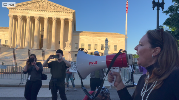 Theresa Brennan, Esq., President of the Right to Life League, with bull horn before the Supreme Court defending Dobbs decision leaked May 2022.