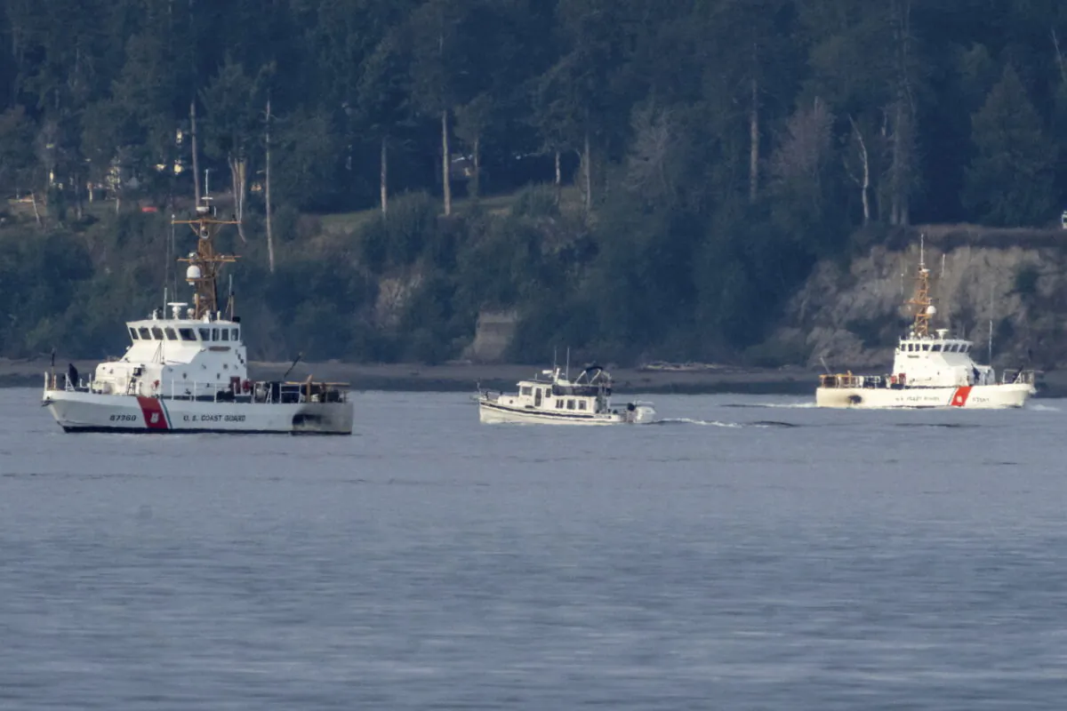 A pair of U.S. Coast Guard vessels search the area on Whidbey Island near Freeland, Wash., on Sept. 5, 2022. (Stephen Brashear/AP Photo)