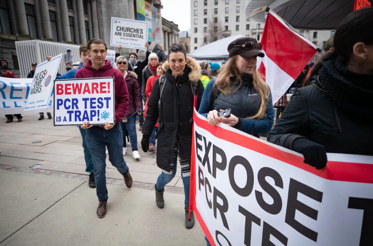 Ontario nurse Kristen Nagle (C) marches in the B.C. Grand Freedom Rally in Vancouver on Feb. 20, 2021. (The Canadian Press/Darryl Dyck)