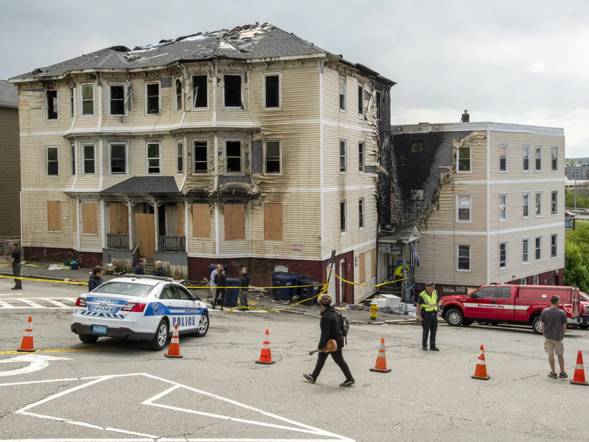 Officials investigate the scene of a fatal fire in Worcester, Mass., on May 17, 2022.  (Rick Cinclair/Worcester Telegram & Gazette via AP)