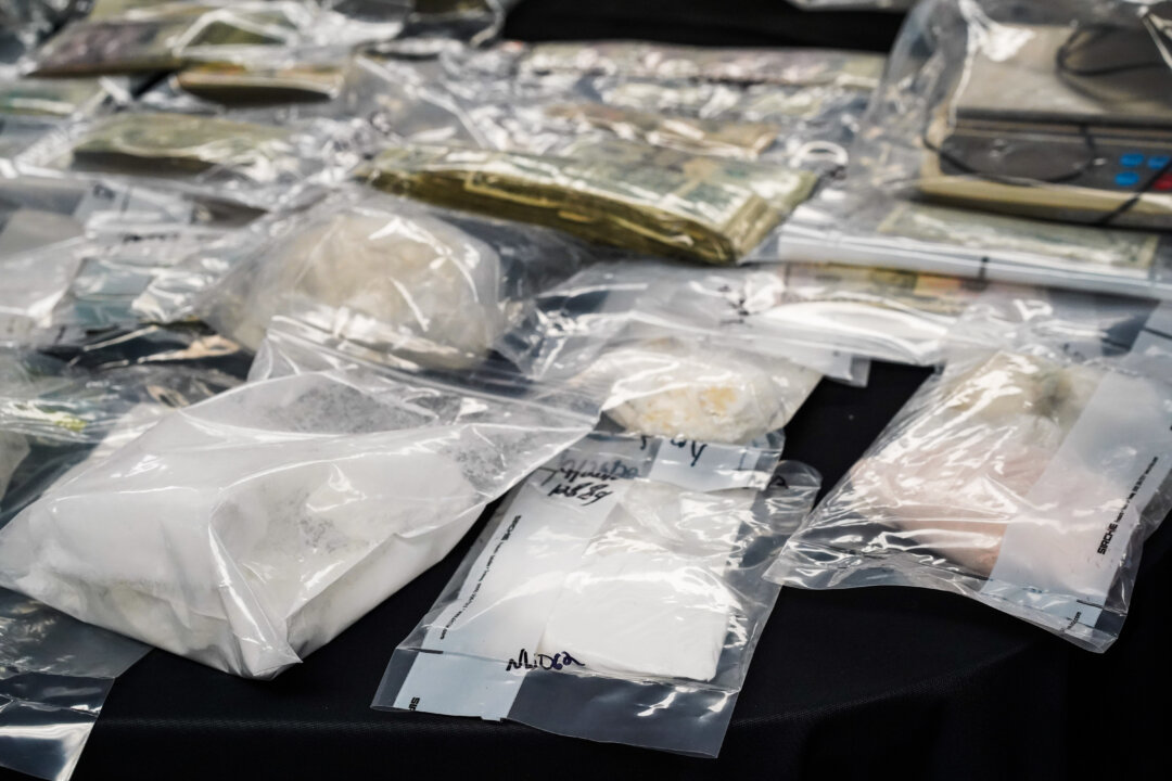 Illegal drugs and cash seized during drug raids on Sept. 26 is on display druing a press conference at Port Jervis City Hall in N.Y., on September 28, 2022. (Cara Ding/The Epoch Times)