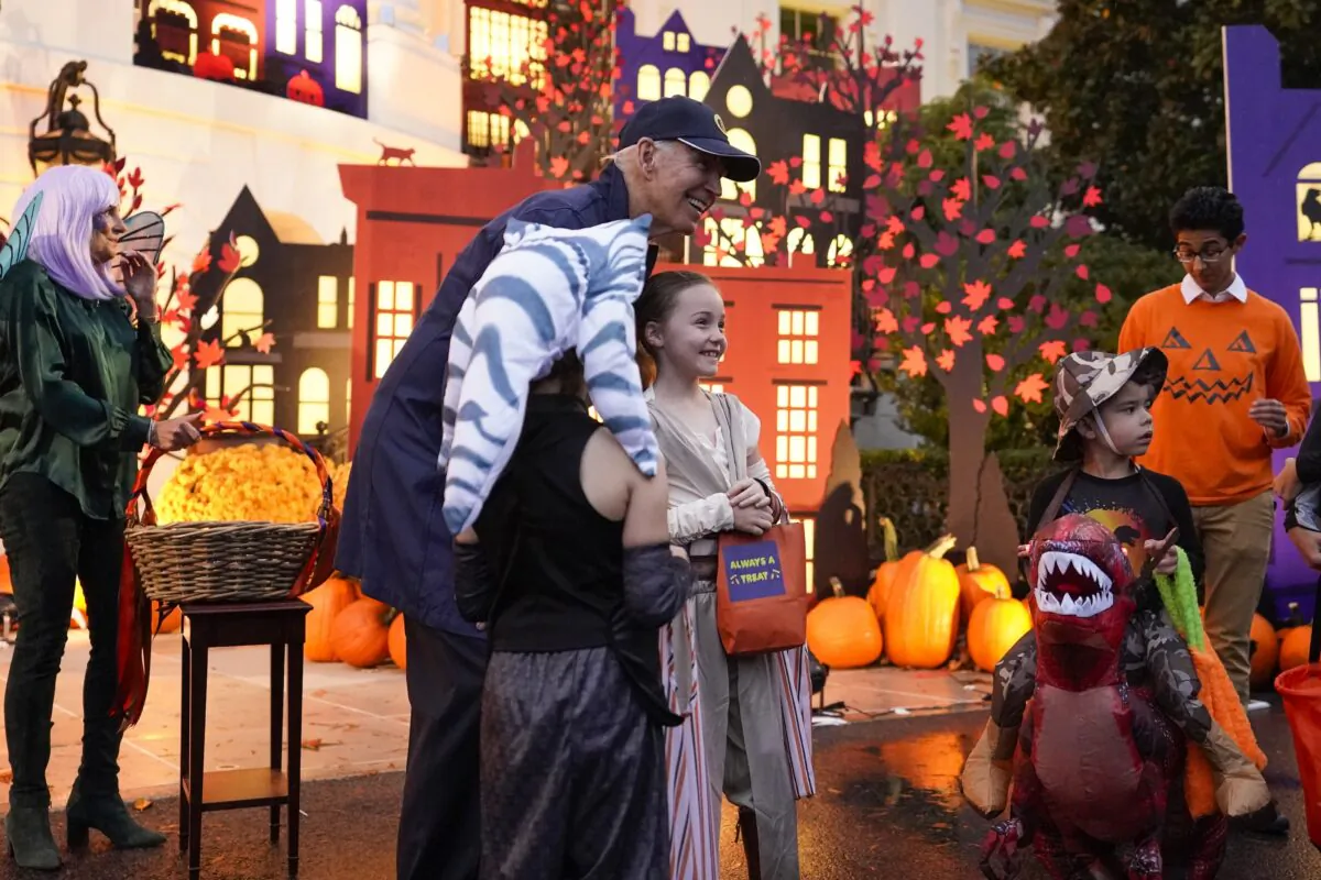 President Joe Biden and First Lady Jill Biden give treats to trick-or-treaters on the South Lawn of the White House on Oct. 31, 2022. (Alex Brandon/AP Photo)