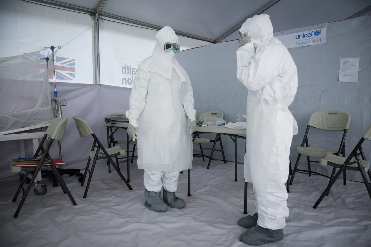 Medical staff members of the Ebola Treatment Unit (ETU) put on their Personal Protective Equipment (PPE) as they get ready to work during a weekly rehearsal at Bwera General Hospital in Bwera bordering with DRC, western Uganda, on Dec. 12, 2018. (Isaac Kasamani/AFP via Getty Images)