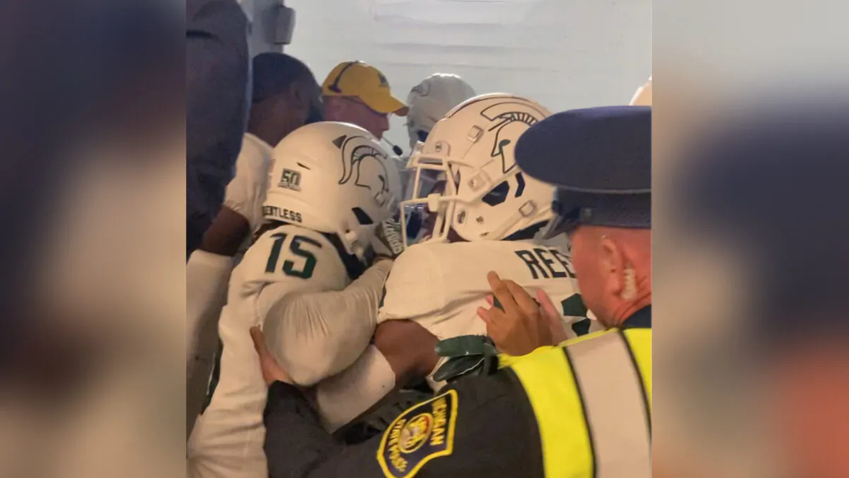 Security and police break up a scuffle between players from Michigan and Michigan State football teams in the Michigan Stadium tunnel after an NCAA college football game in Ann Arbor, Mich., on Oct. 29, 2022. (Kyle Austin/MLive Media Group via AP)