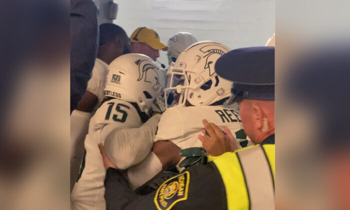 Security and police break up a scuffle between players from Michigan and Michigan State football teams in the Michigan Stadium tunnel after an NCAA college football game in Ann Arbor, Mich., on Oct. 29, 2022. (Kyle Austin/MLive Media Group via AP)