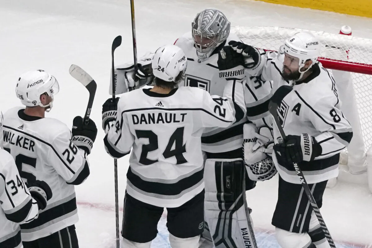 Los Angeles Kings goaltender Jonathan Quick (32) is congratulated by teammates Phillip Danault (24), Drew Doughty (8) and Sean Walker (26) following an NHL hockey game against the St. Louis Blues in St. Louis, Oct. 31, 2022. (Jeff Roberson/AP Photo)