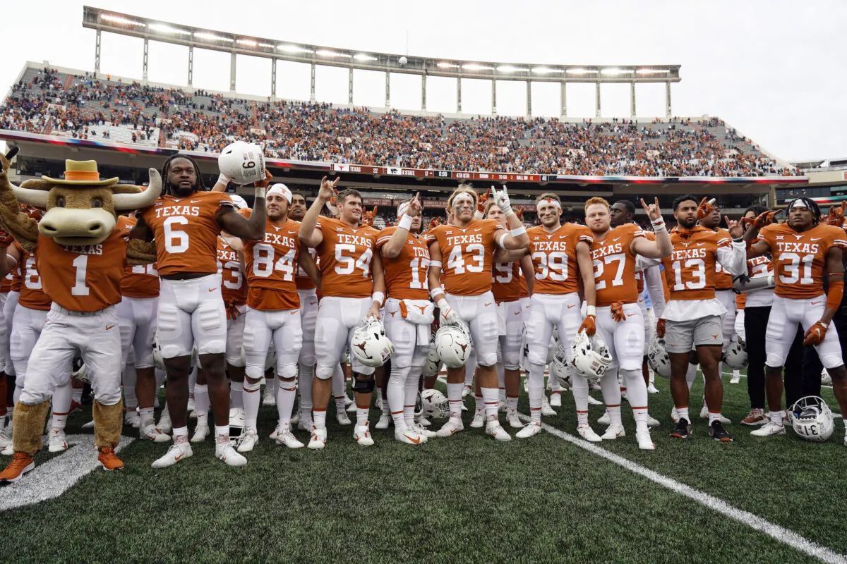 Texas players sing "The Eyes Of Texas," after defeating Kansas State 22-17 in an NCAA college football game in Austin, Texas, on Nov. 26, 2021. The new business world of college athletes getting paid for endorsements has created a rapidly expanding pop-up industry: nonprofits formed to set up athletes with deals that pay them to promote charities. Among the first was Horns With Heart, a nonprofit set up to aid offensive linemen at the University of Texas in 2021. A bill filed Wednesday, Sept. 28, 2022, would eliminate the tax deduction for individuals and for specific contributions that are then paid to athletes for name, image and likeness deals. (Chuck Burton/AP Photo)