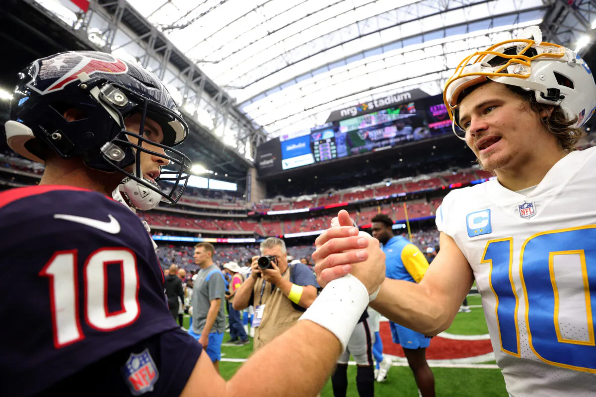 Davis Mills (10) and Justin Herbert (10) of the Los Angeles Chargers meet after the Chargers beat the Texas at NRG Stadium in Houston, on Oct. 2, 2022. (Carmen Mandato/Getty Images)