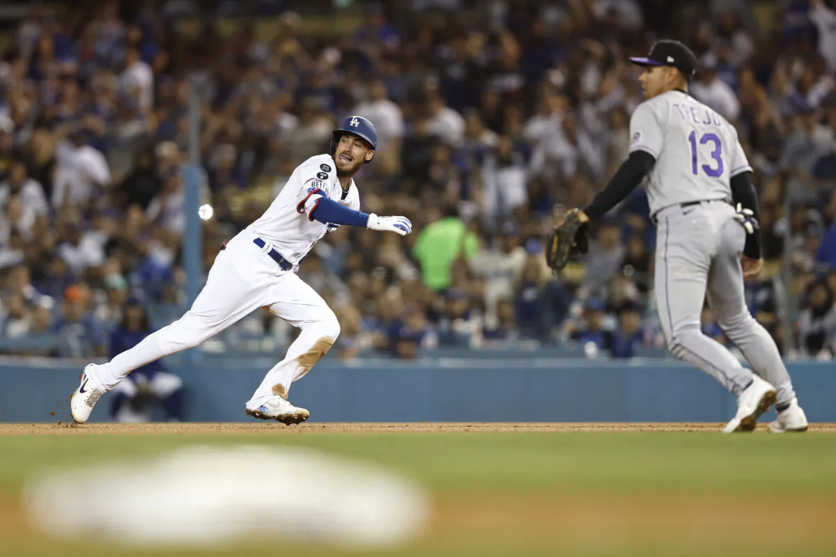 Cody Bellinger (35) of the Los Angeles Dodgers reacts as he runs back to first base after an error by the Colorado Rockies during the sixth inning at Dodger Stadium in Los Angeles, on Oct. 1, 2022. (Michael Owens/Getty Images)