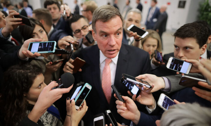 Reporters surround Senate Intelligence Committee ranking member Sen. Mark Warner (D-VA) as he heads for his party's weekly policy luncheon at the U.S. (Photo by Chip Somodevilla/Getty Images)