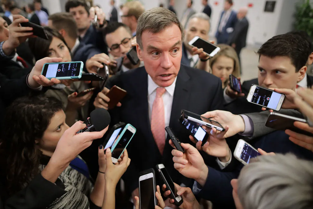 Reporters surround Senate Intelligence Committee ranking member Sen. Mark Warner (D-VA) as he heads for his party's weekly policy luncheon at the U.S. (Photo by Chip Somodevilla/Getty Images)