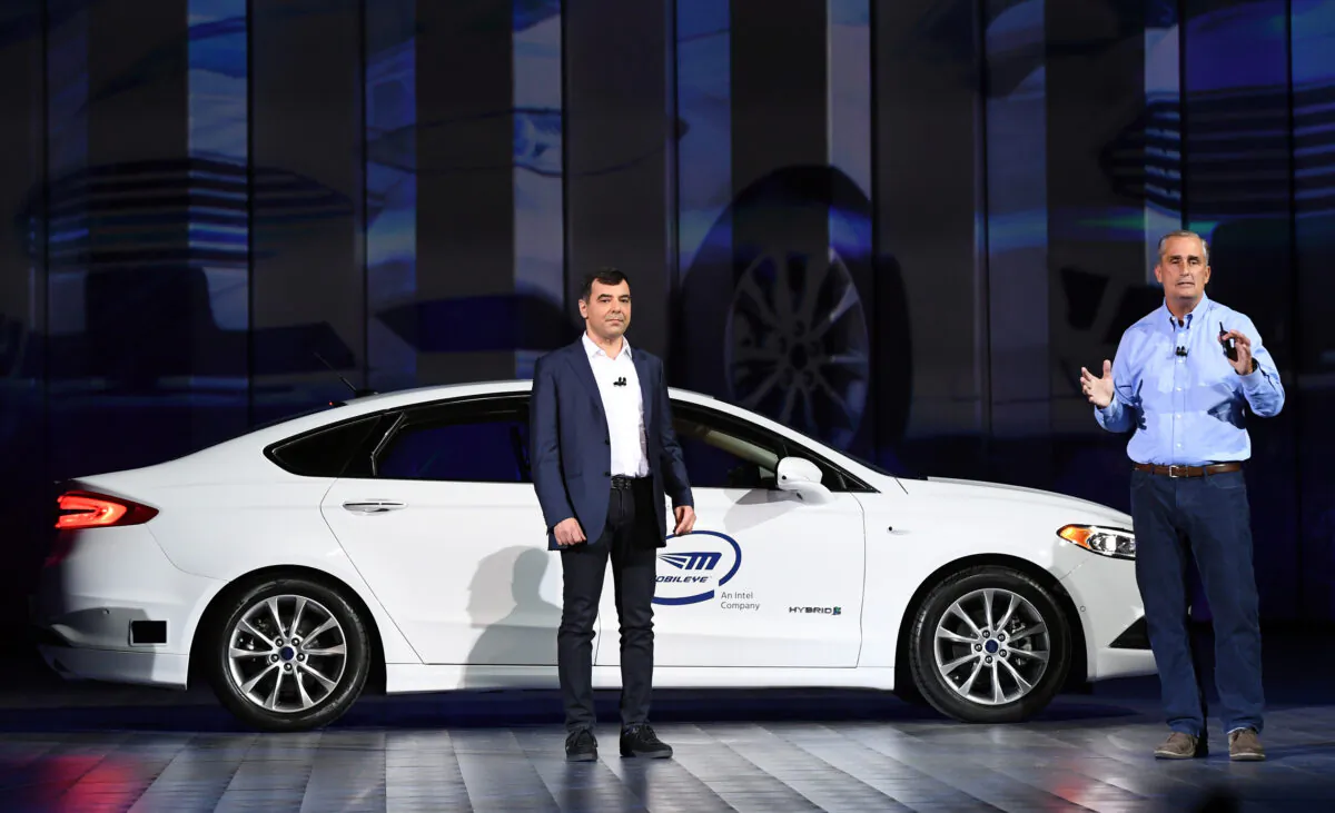 Intel Corp. Senior Vice President and CEO and Chief Technology Officer of Mobileye Amnon Shashua (L) speaks in front of a Ford Fusion with Mobileye autonomous driving technology during a keynote address by Intel Corp. CEO Brian Krzanich at CES 2018 at Park Theater at Monte Carlo Resort and Casino in Las Vegas, Nevada on January 8, 2018. (Ethan Miller/Getty Images)