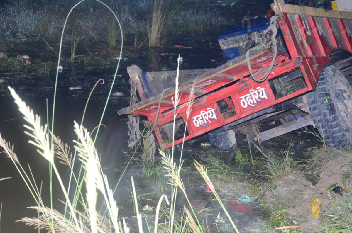 A farm tractor fallen in a pond in Ghatampur area of Kanpur, 100 kilometers (62 miles) southwest of Lucknow, the state capital of Indian state of Uttar Pradesh, on Oct. 1, 2022. (AP Photo)
