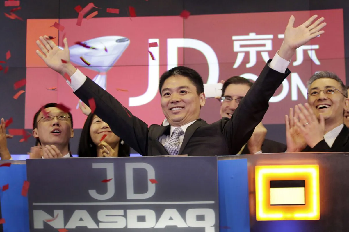Liu Qiangdong, also known as Richard Liu, CEO of JD.com, raises his arms to celebrate the IPO for his company at the Nasdaq MarketSite in New York on May 22, 2014. (Mark Lennihan/AP Photo)
