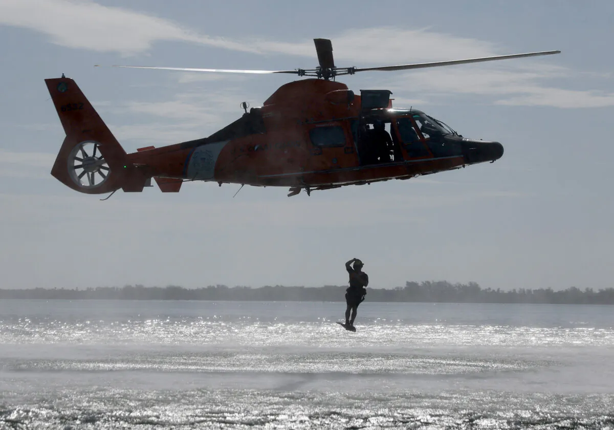 Crew members in a U.S. Coast Guard MH 65 Dolphin helicopter participate in a training exercise in Miami Beach, Fla., on June 9, 2022. (Joe Raedle/Getty Images)
